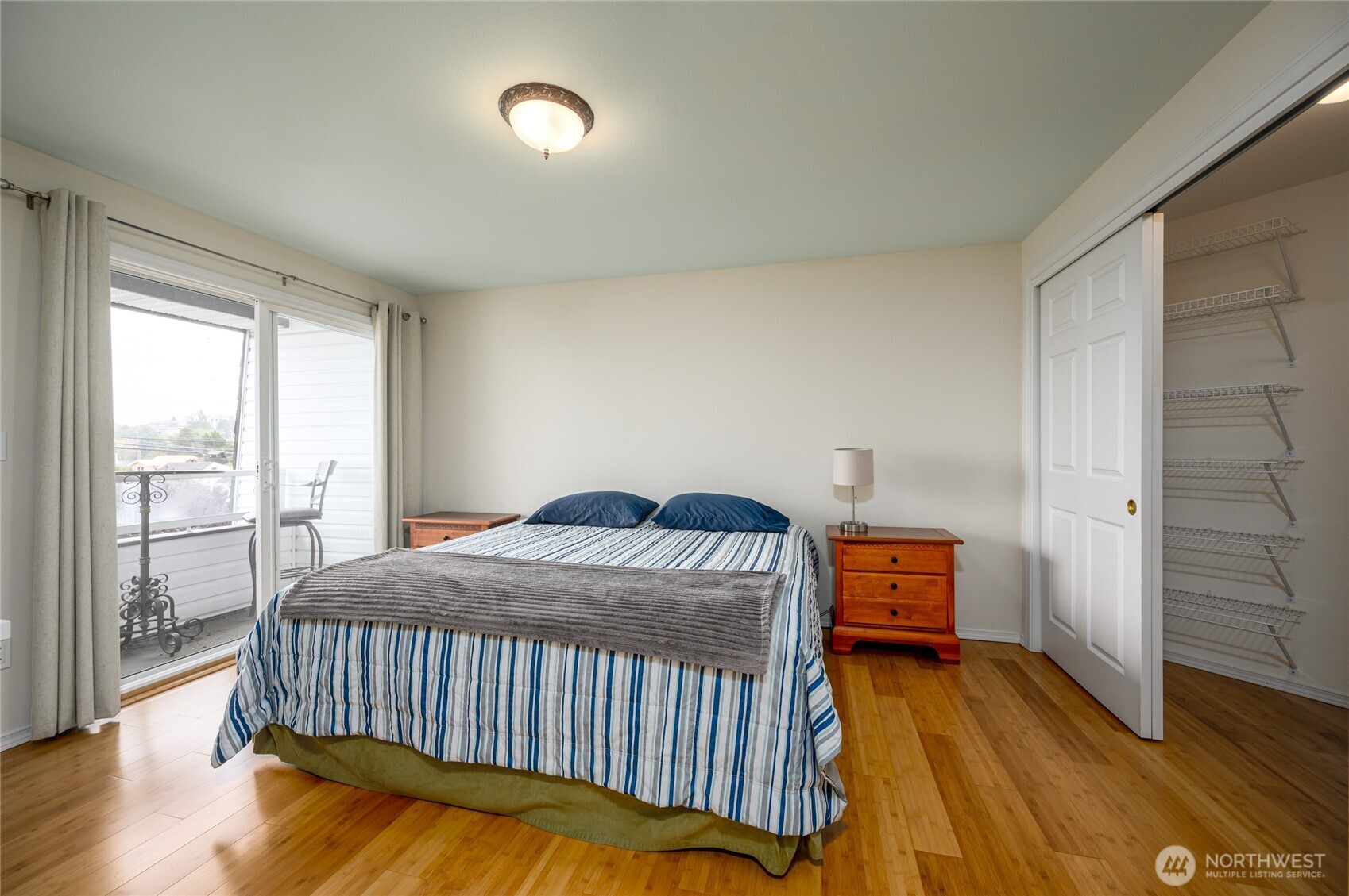 910 34th Street, Unit 202 Anacortes, WA 98221 - Photo 10 of 20 a bedroom with a bed and wooden floor