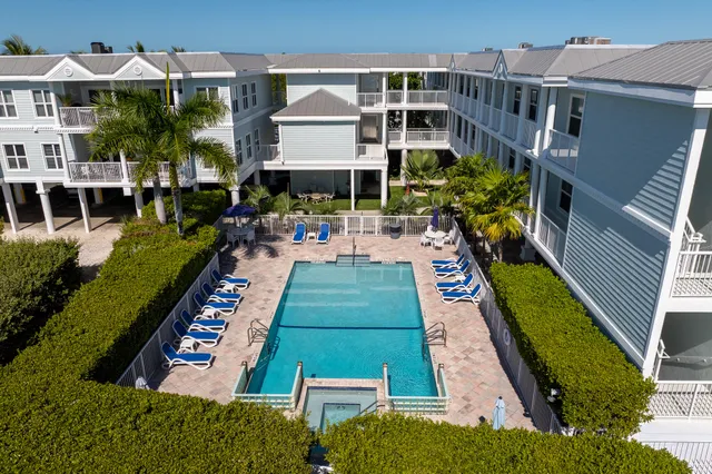 a view of a house with a yard and potted plants