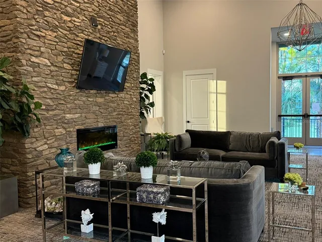 a living room with furniture a fireplace and a flat screen tv