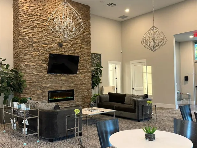 a living room with fireplace furniture and a wooden floor