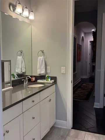 a bathroom with a double vanity sink and a mirror