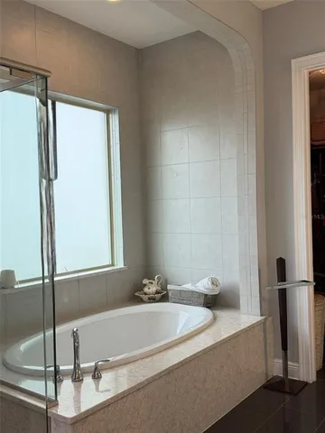 a bathroom with a bathtub and a shower