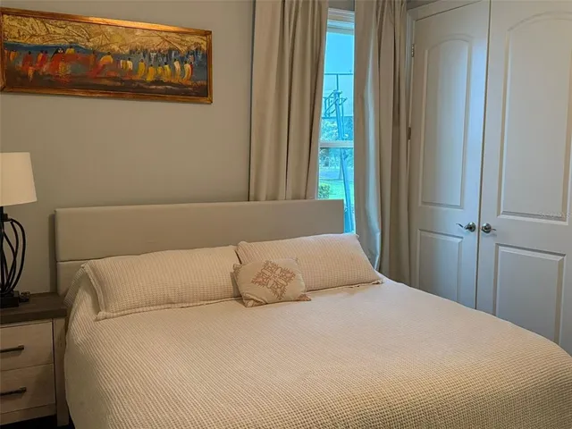 a bedroom with a bed and a window