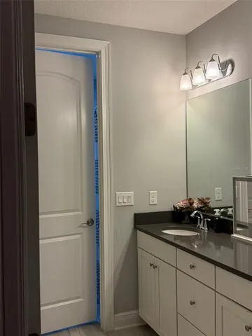 a bathroom with a double vanity sink and a mirror