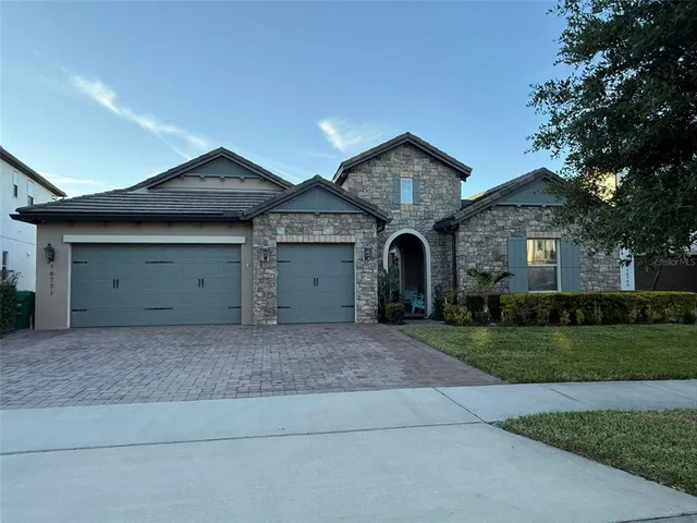 a view of a house with a yard and garage