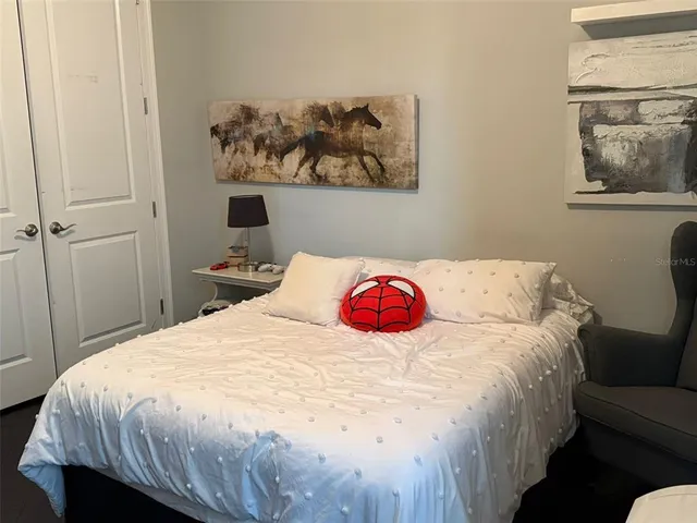 a bedroom with a bed and wall painting