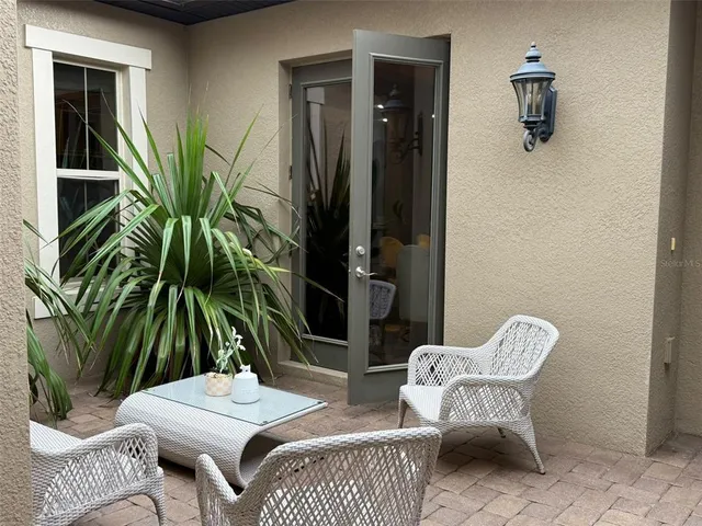 a dining room with furniture and a potted plant