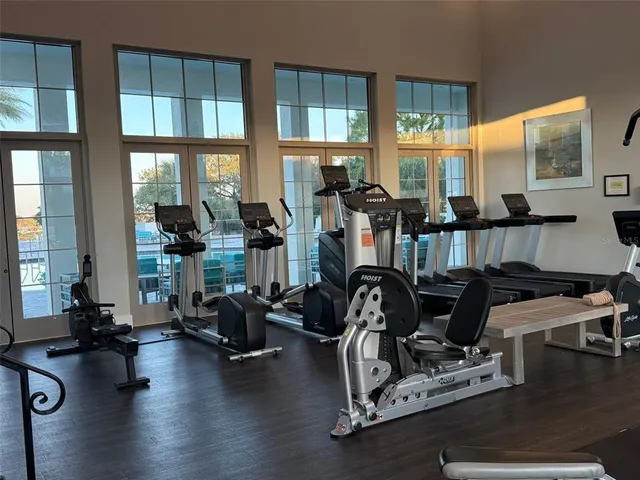 a room with gym equipment and a large window