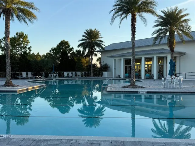 a view of a swimming pool with a table and chairs