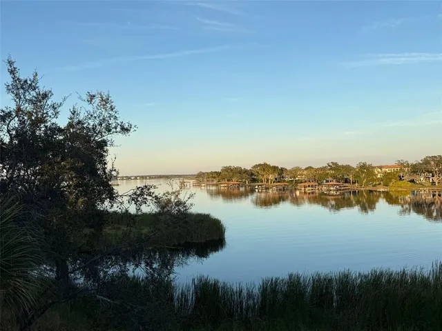 a view of a lake with a table and chairs