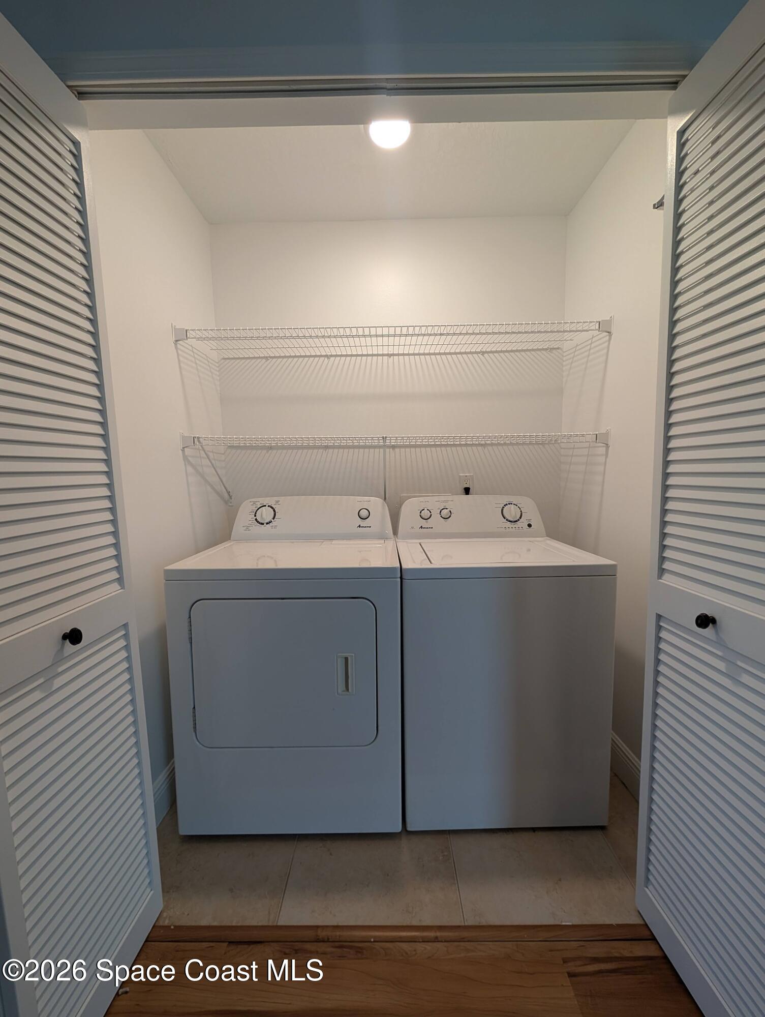 7667 North Wickham Road, Unit 818 Melbourne, FL 32940 - Photo 12 of 29 a utility room with washer and dryer