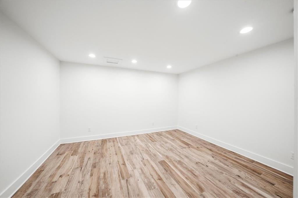 1710 Rising Mist Lane Cumming, GA 30041 - Photo 76 of 111 a view of room with wooden floor and white walls