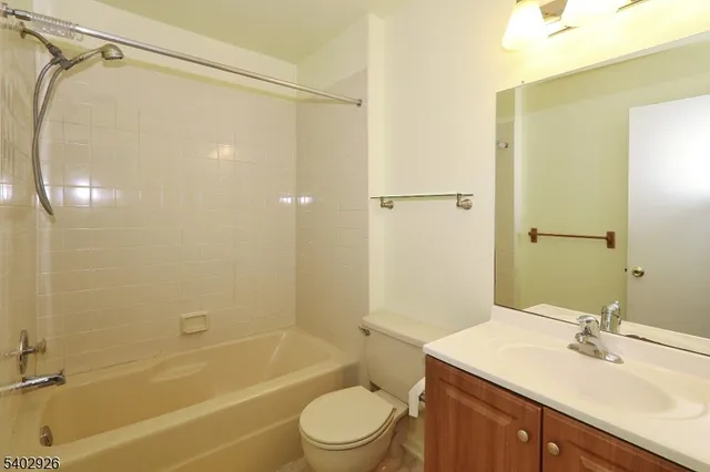 a bathroom with a sink mirror toilet and bathtub