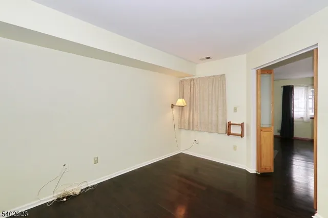 a view of a room with wooden floor