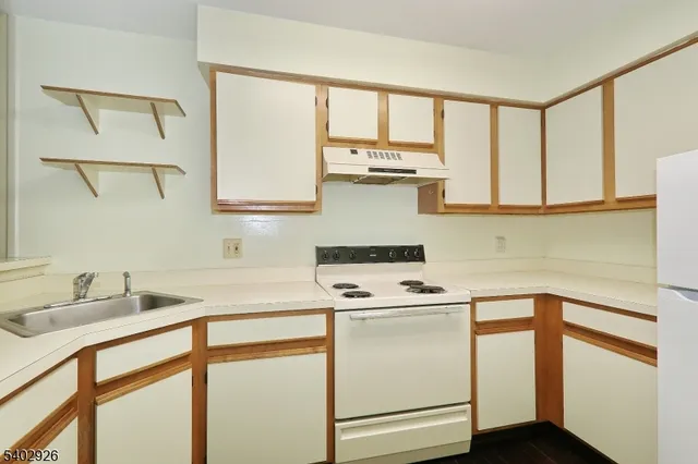 a kitchen with appliances cabinets and a sink