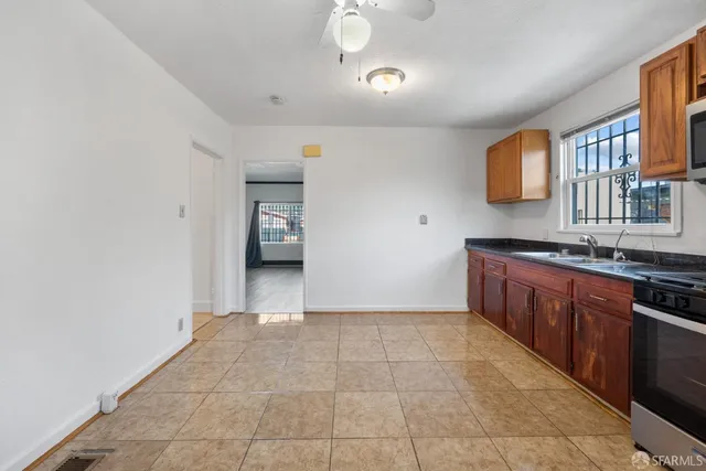 a view of a kitchen with a sink and a window