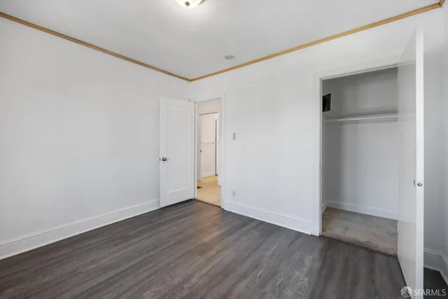 a view of a bathroom with closet and mirror