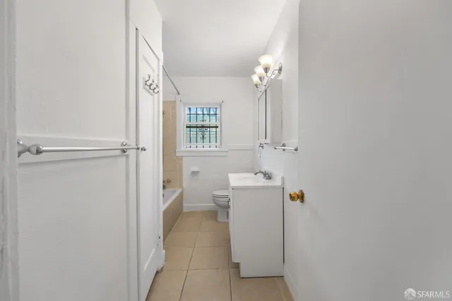 a bathroom with a sink a toilet and bathtub