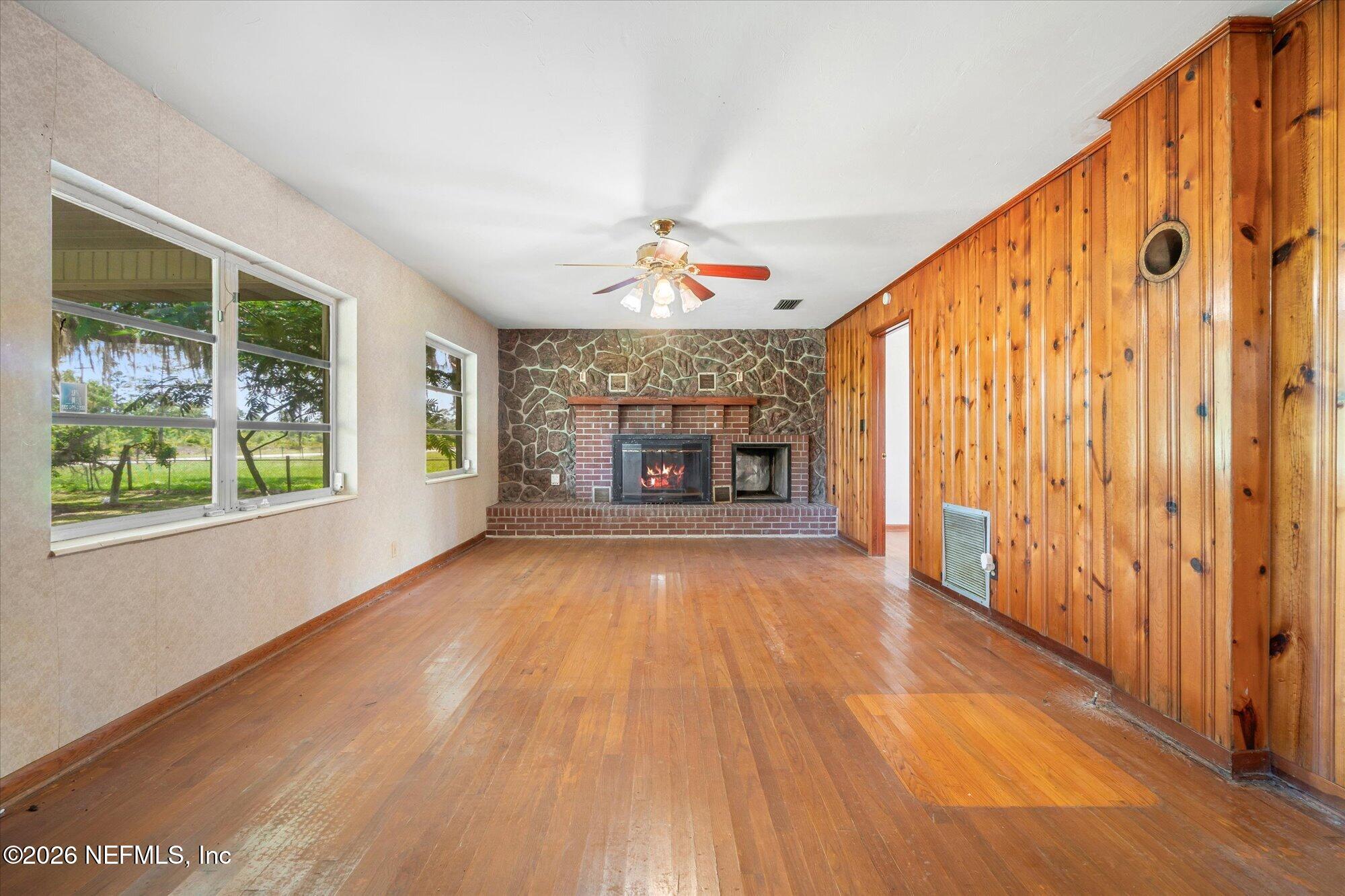 786 West River Road Palatka, FL 32177 - Photo 10 of 53 wooden floor in an empty room with a window