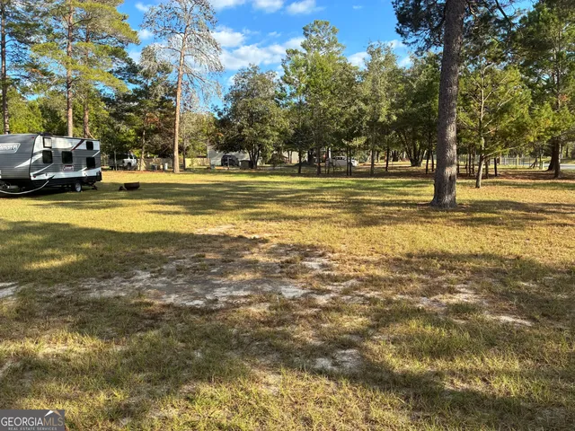 a swimming pool with outdoor seating and yard