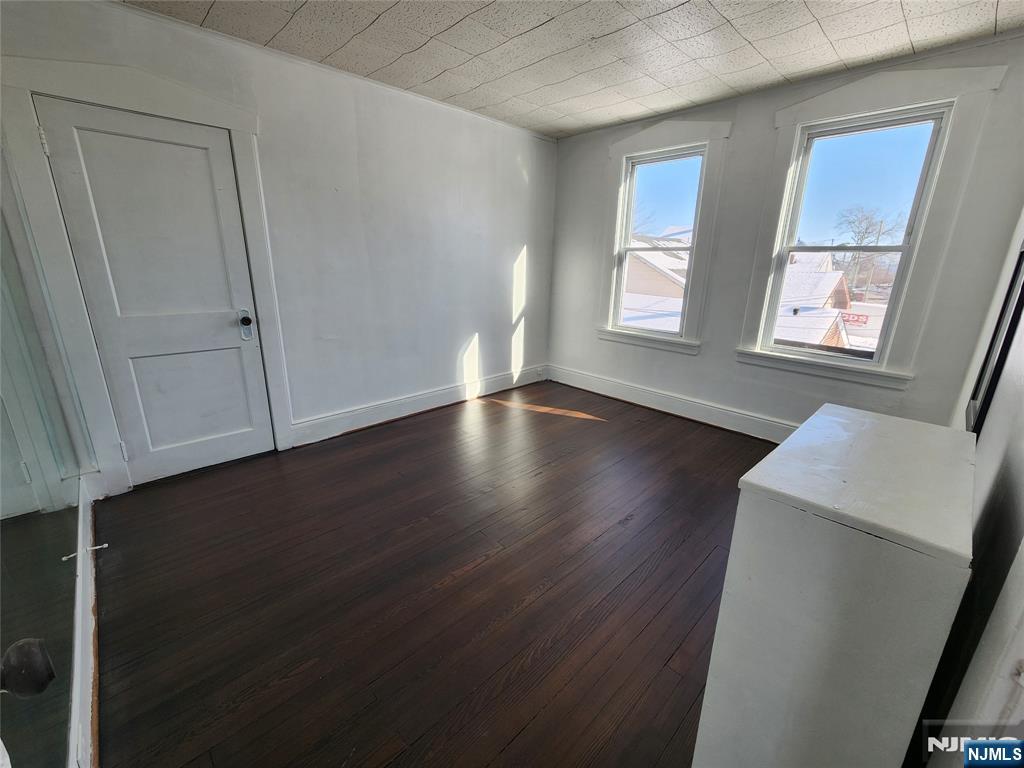 752 Ridge Road Lyndhurst, NJ 07071 - Photo 12 of 19 a view of an empty room with wooden floor and a window