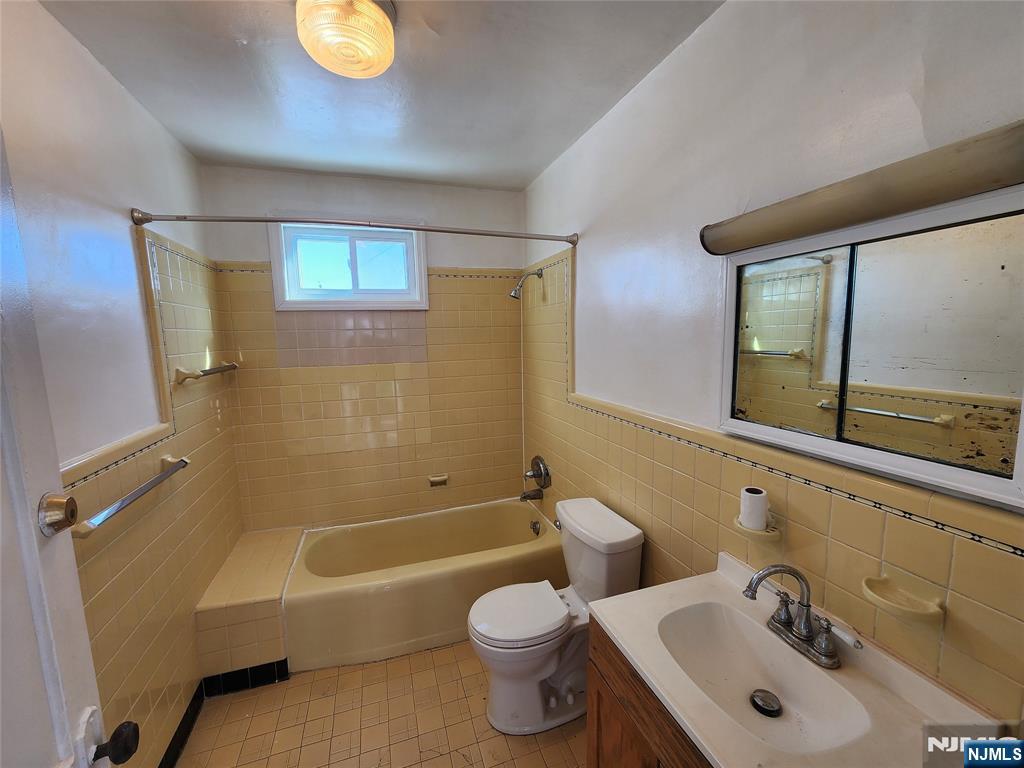 752 Ridge Road Lyndhurst, NJ 07071 - Photo 15 of 19 a bathroom with a sink mirror toilet and bathtub