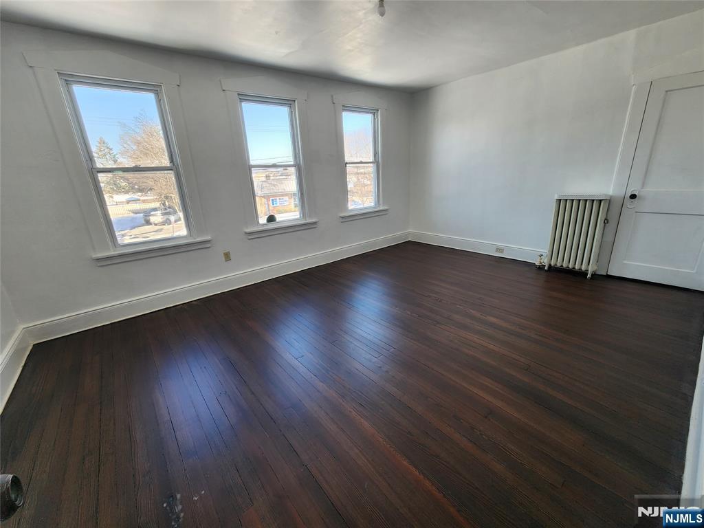 752 Ridge Road Lyndhurst, NJ 07071 - Photo 18 of 19 an empty room with wooden floor and windows