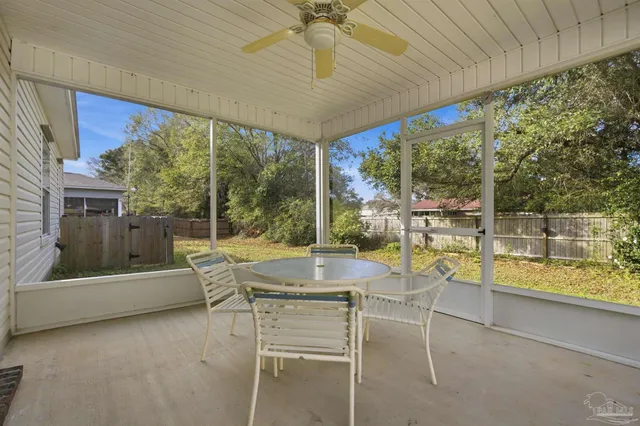 a dining room with furniture and a floor to ceiling window