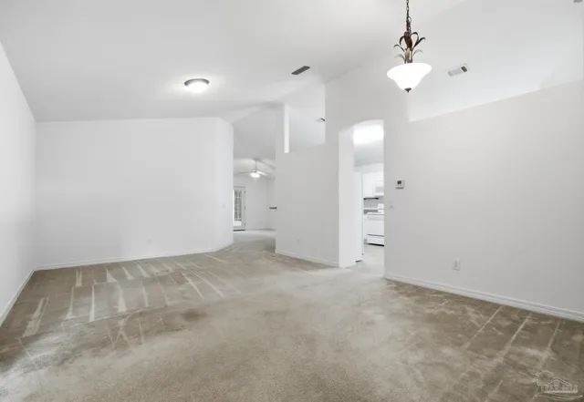 an empty room with a ceiling fan and bathroom