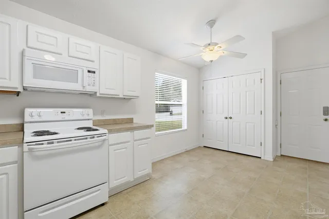 a view of a kitchen with electric appliances
