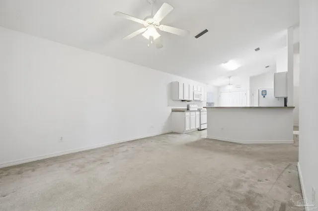 en empty room with kitchen and window