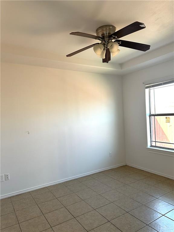 3800 South Sheraton Avenue Pharr, TX 78577 - Photo 10 of 11 an empty room with windows and ceiling fan