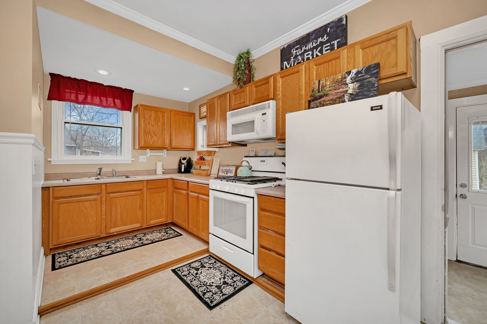 565 East Norris Drive Ottawa, IL 61350 - Photo 11 of 42 a kitchen with stainless steel appliances a refrigerator sink and white cabinets