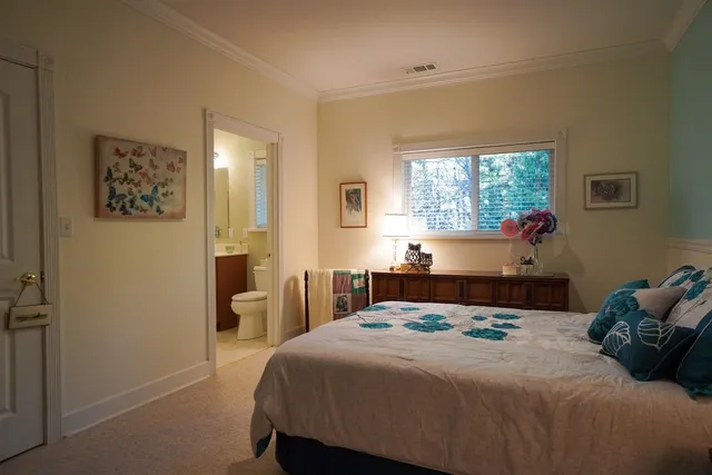 a living room filled with furniture a fireplace and a chandelier