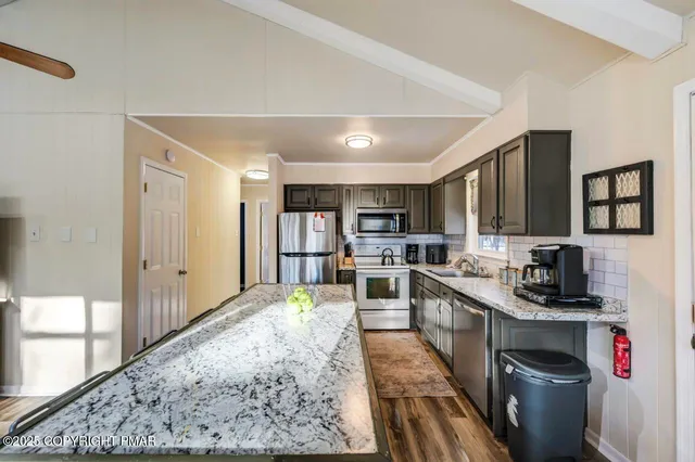 a living room with furniture fireplace and a chandelier