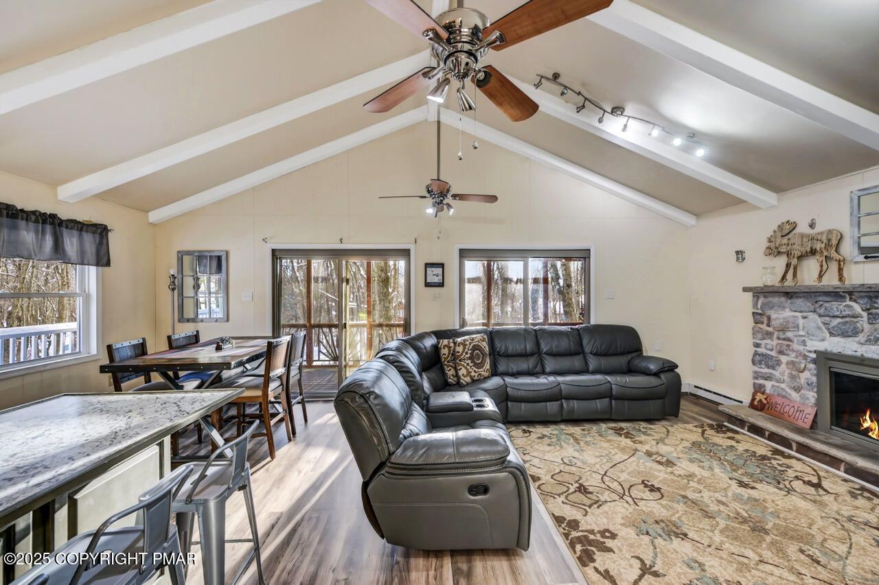 124 Fern Ridge Road Blakeslee, PA 18610 - Photo 20 of 69 a living room with furniture fireplace and a chandelier
