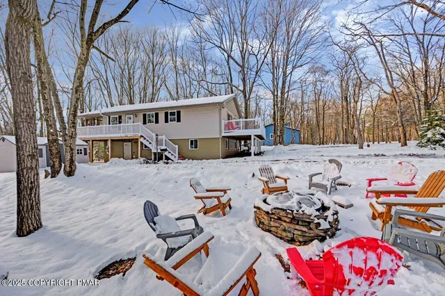 a living room with furniture a fireplace and a table