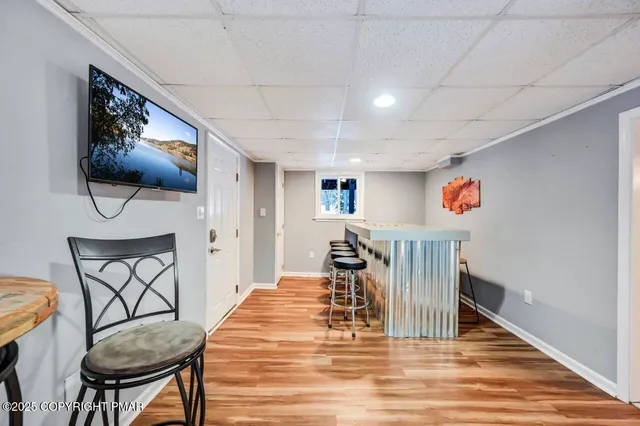 a front view of a building with large trees