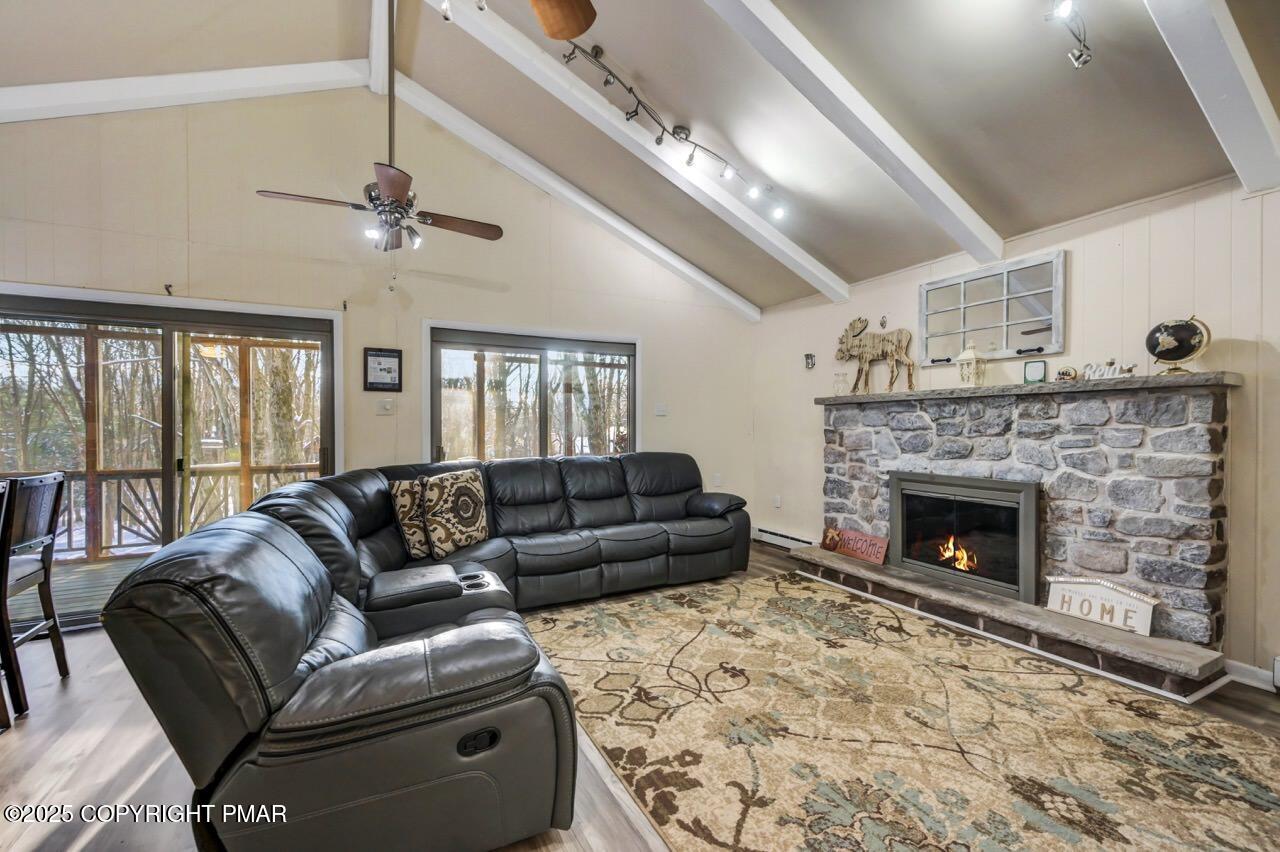 124 Fern Ridge Road Blakeslee, PA 18610 - Photo 9 of 69 a living room with furniture and a fireplace