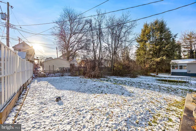 a view of a house with a yard covered in snow