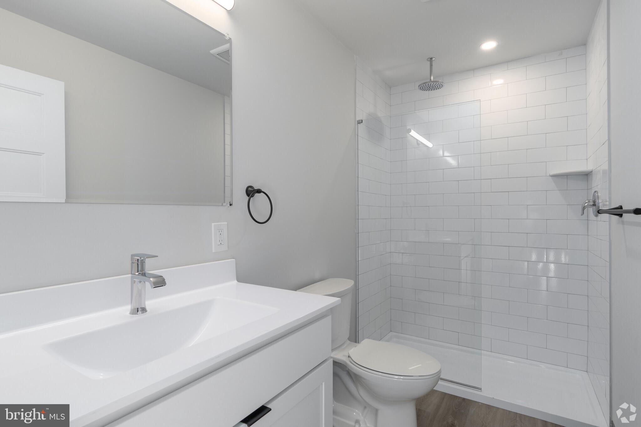 224 Hall Street, Unit 7 Phoenixville, PA 19460 - Photo 3 of 14 a bathroom with a sink toilet and shower