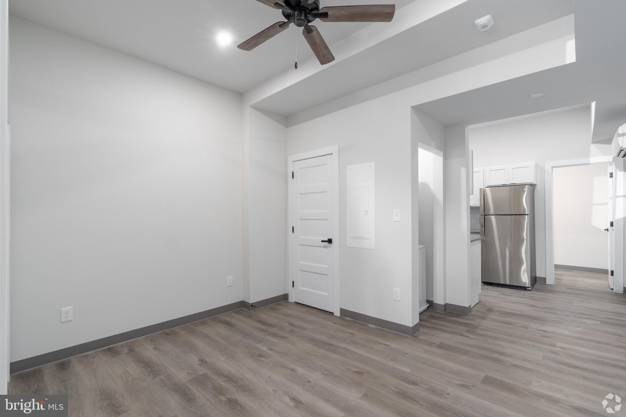 224 Hall Street, Unit 7 Phoenixville, PA 19460 - Photo 6 of 14 a view of a livingroom with wooden floor and a ceiling fan
