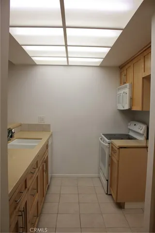a utility room with sink dryer and washer