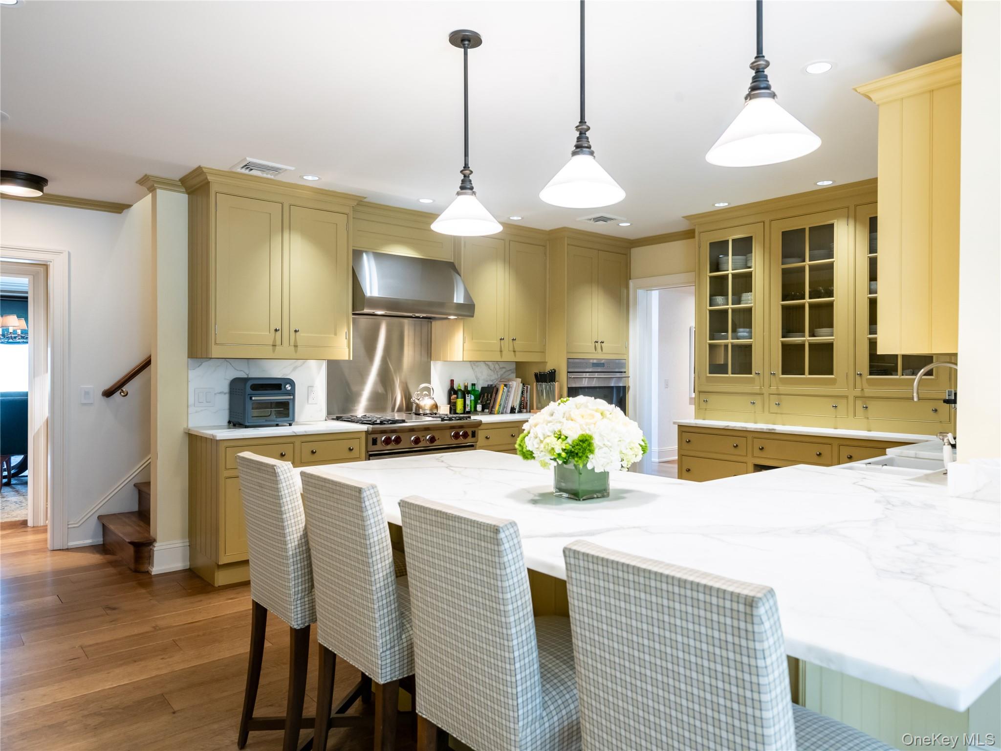 90 Elderfields Road Manhasset, NY 11030 - Photo 12 of 35 a view of a dining room and kitchen with a chandelier