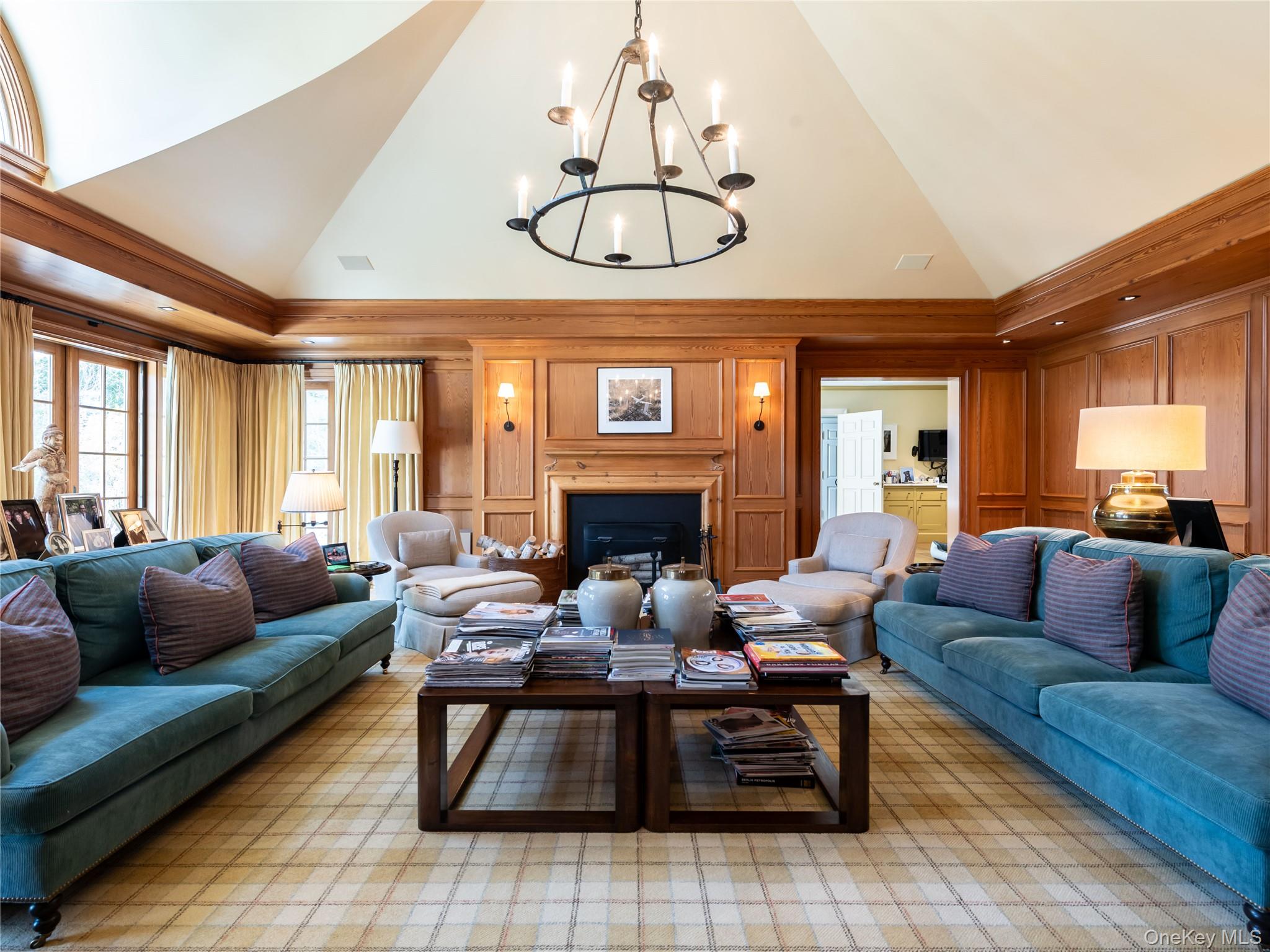 90 Elderfields Road Manhasset, NY 11030 - Photo 17 of 35 a living room with furniture a fireplace and a chandelier