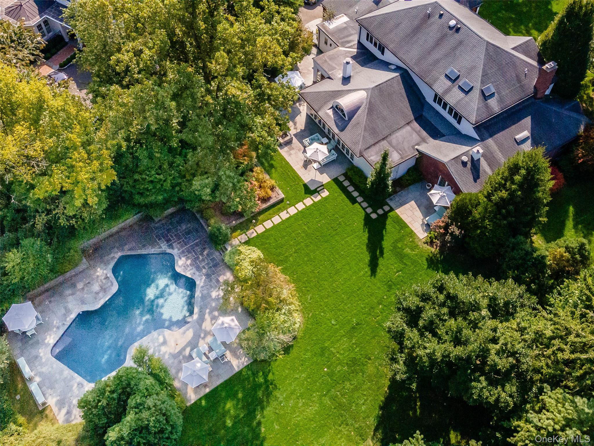 90 Elderfields Road Manhasset, NY 11030 - Photo 2 of 35 an aerial view of a house with a garden