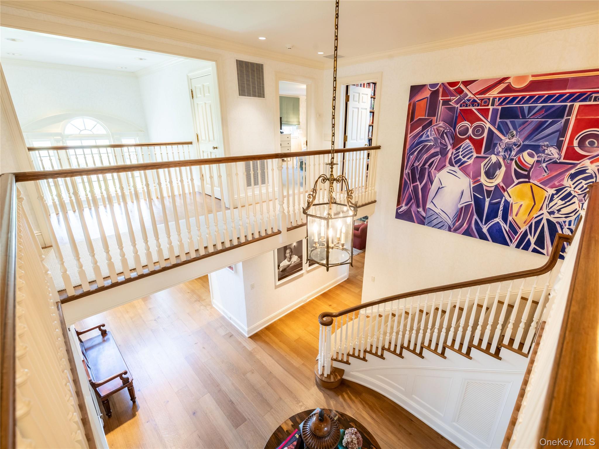 90 Elderfields Road Manhasset, NY 11030 - Photo 26 of 35 a view of a hallway with wooden floor and staircase