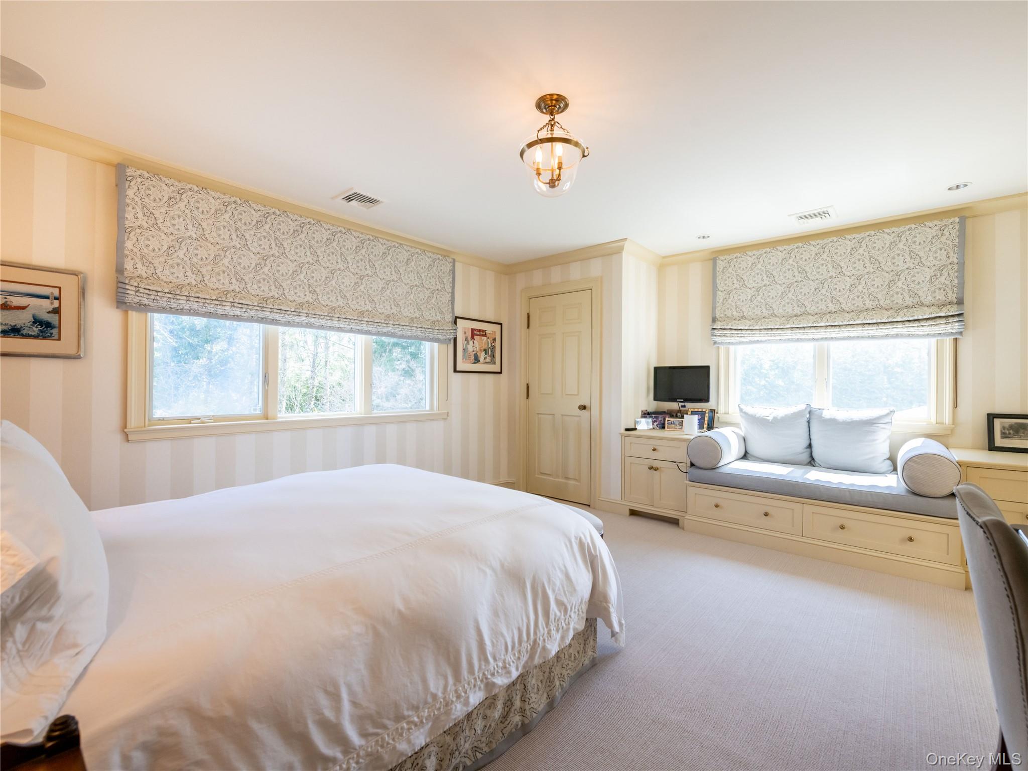 90 Elderfields Road Manhasset, NY 11030 - Photo 27 of 35 a spacious bedroom with a bed and a large window