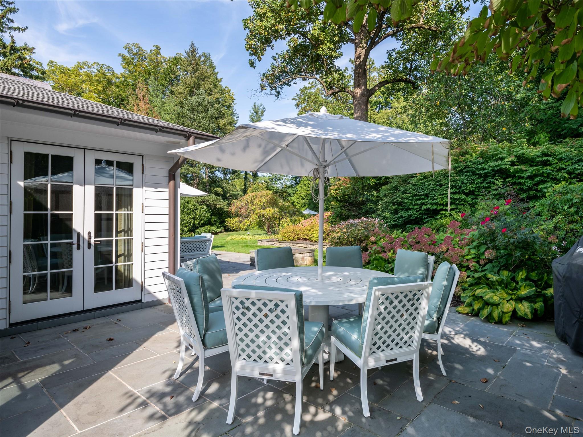 90 Elderfields Road Manhasset, NY 11030 - Photo 33 of 35 a patio with a patio table and chairs