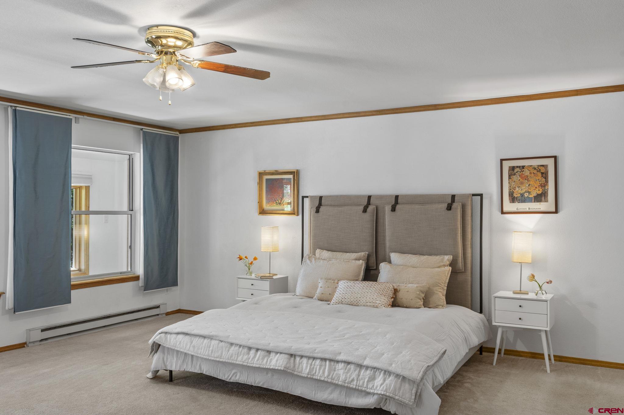 37 Verde Lane Durango, CO 81301 - Photo 16 of 45 a bedroom with a bed and a chandelier